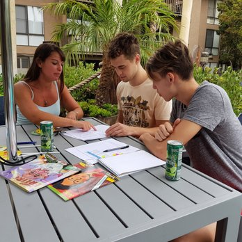 Three students learning Spanish together in a small group class