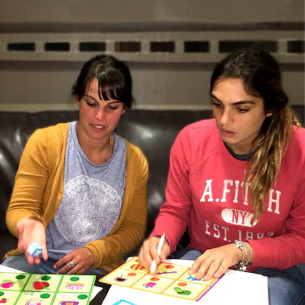 Debbie teaching Spanish with colorful vocabulary cards during an in-person lesson
